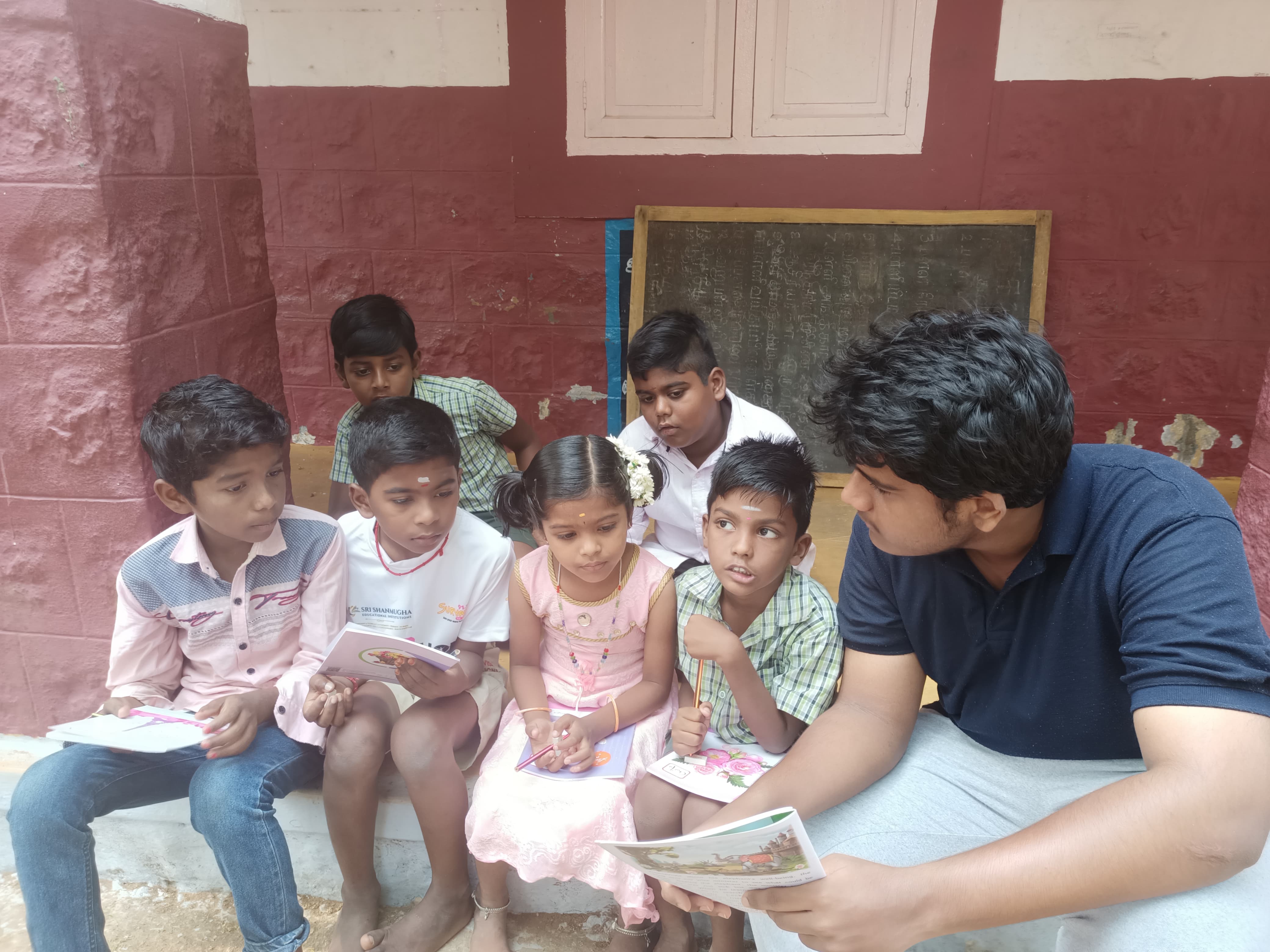 Founder teaching a group of children